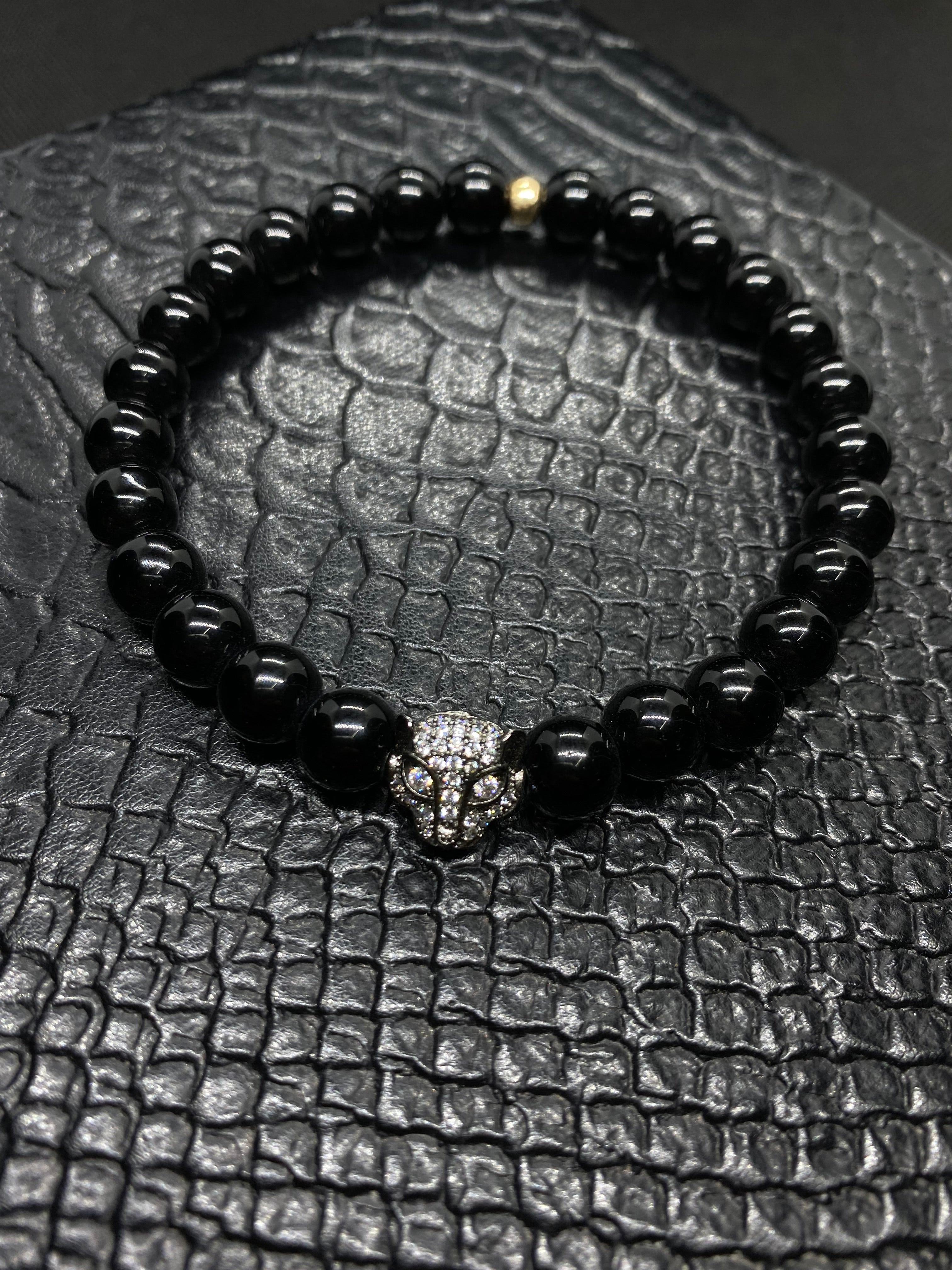 PULSERA ELASTICA PIEDRA ONIX BRILLANTE CON GUEPARDO DE RODIO CON INCRUSTACIONES DE ZIRCONIAS